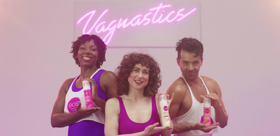The header image shows three people holding up Eos products with a lit-up neon sign behind them that reads "Vagnastics."