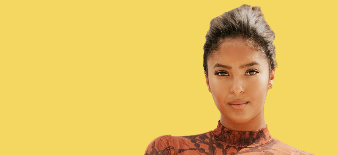 Natalia Bryant in front of yellow background