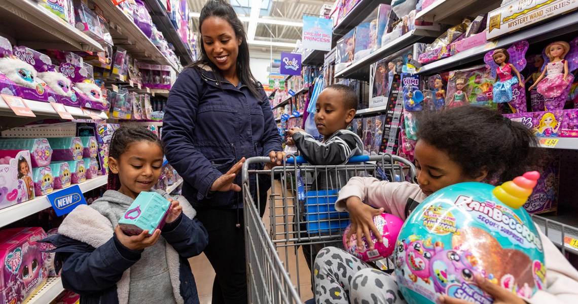 a-family-checks-out-new-holiday-toys-in-a-walmart-store-aisle